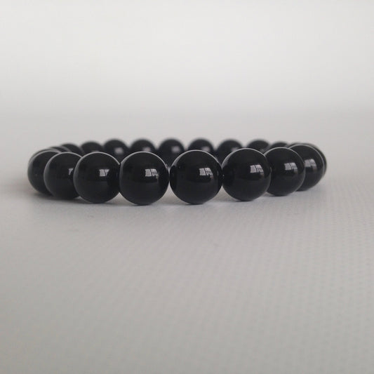 Manilla polo a tierra con onix: limpia y transmuta